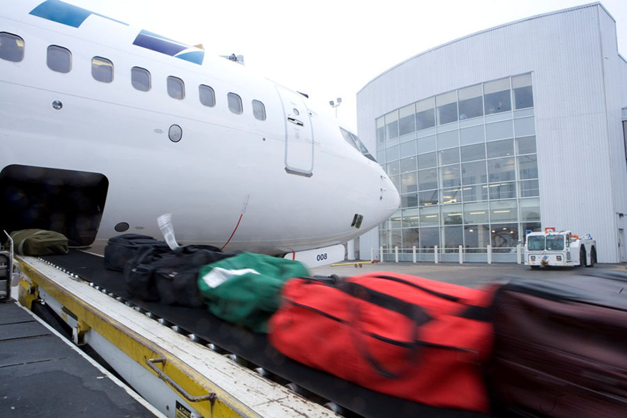 Loading luggage onto a plane