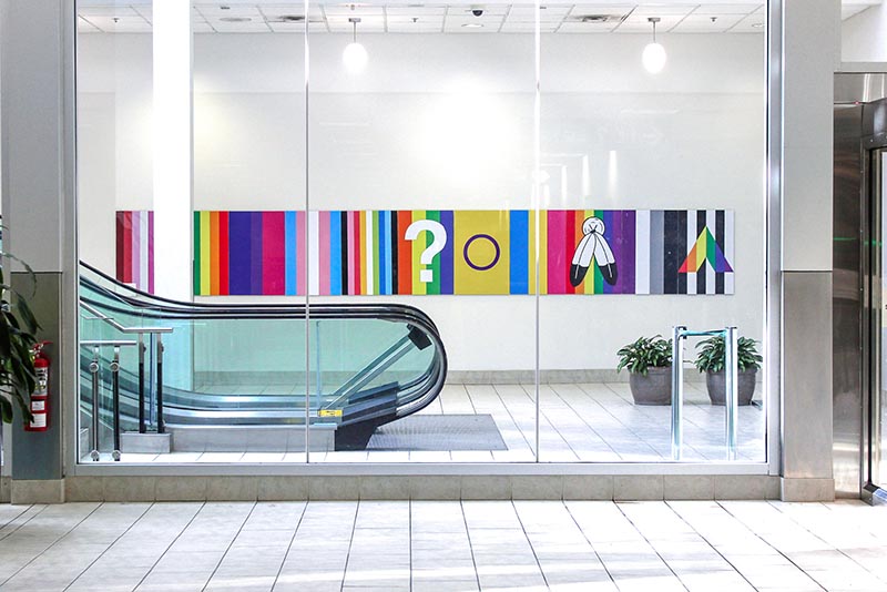 A photo of an artistic mural beside an escalator